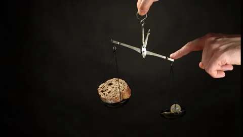 Lever scale with bread and coins on dark background Stock Footage 201286009