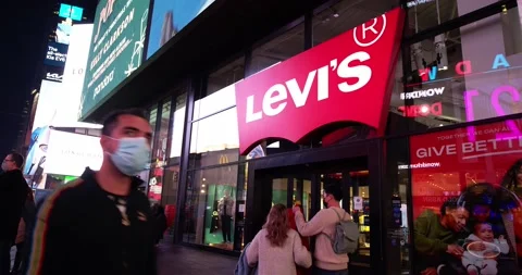 Levi's store on Times Square in Manhattan at night. People enjoying sightseeing Stock Footage 219883686