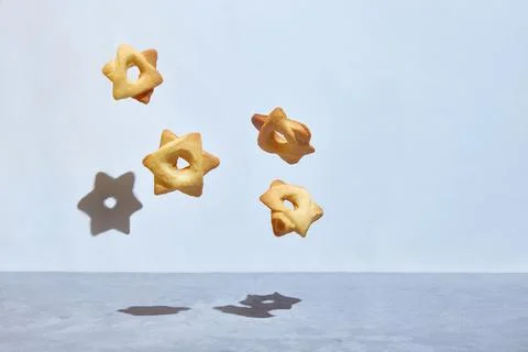Levitating cookies in the shape of a hexagonal star of David. hexagram. Foto stock