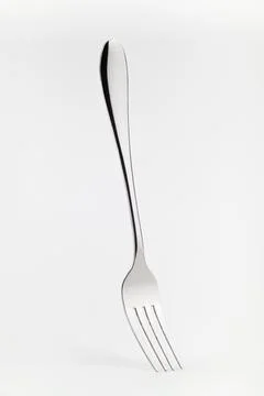 Levitating fork on a white background. Front view. Stock Photos