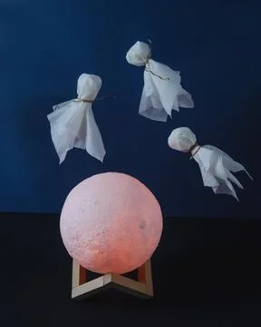 Levitating ghosts in over the moon on dark background Stock Photos