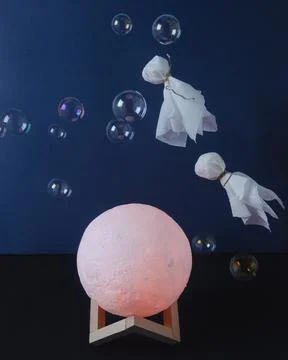 Levitating ghosts in soap bubbles over the moon Stock-Fotos