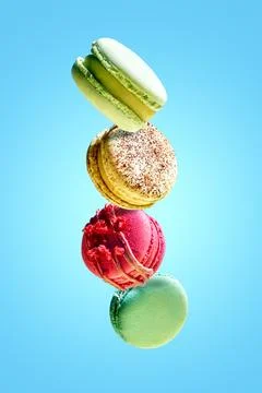 Levitating macaron with different flavors. Bright colours. French pastries... Stock Photos