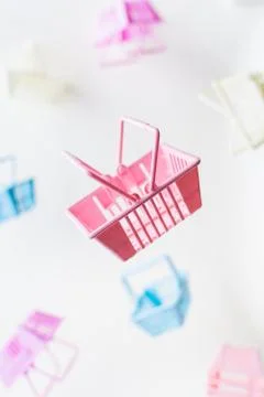 Levitating plastic shopping baskets on white background Stock Photos