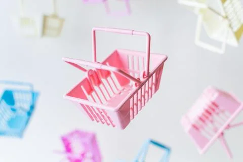 Levitating plastic shopping baskets on white background Stock Photos