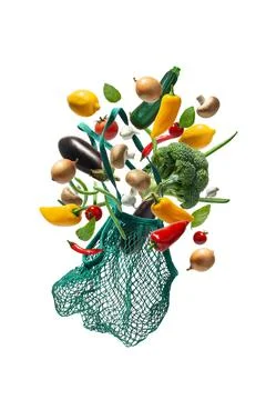 Levitating string bag with vegetables. Eco friendly. Bag with falling vegetab Stock Photos