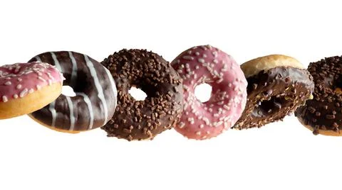 Levitating a variety of donuts on a white background Stock Photos