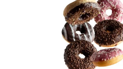 Levitating a variety of donuts on a white background Stock Photos