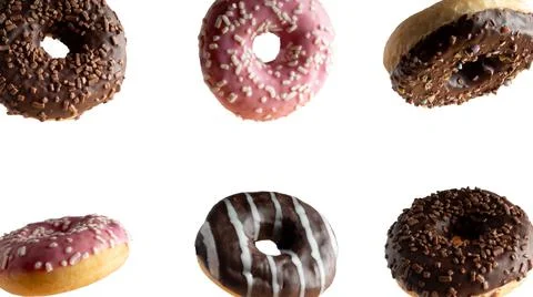 Levitating a variety of donuts on a white background Stock Photos