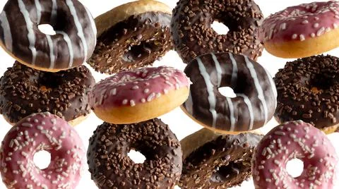 Levitating a variety of donuts on a white background Stock Photos