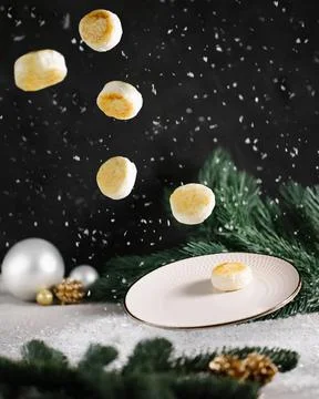 Levitation with a flying cottage cheese pancakes winter set up Christmas mood Stock Photos