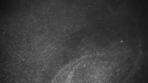 Levitation of rotating and twisting particles of sand dust in the air 動画素材 233637334