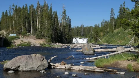 Lewis Falls with part of the bridge over the Lewis River,  Wyoming Stock Footage 112772243