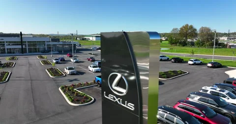 Lexus car dealership. New and used cars for sale. Rising aerial of sign Stock Footage