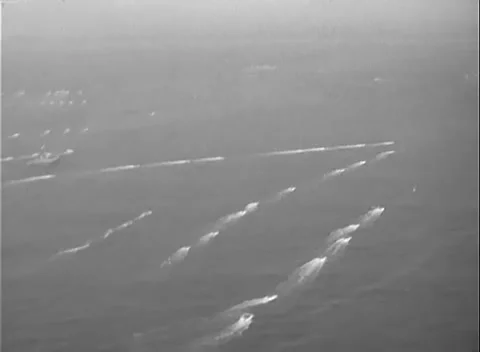 LEYTE, PHILIPPINES - 1945: Wake patterns - Craft pass a cluster of ships Stock Footage 347228820