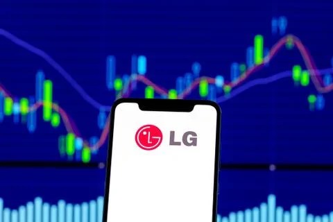LG logo is seen on an smartphone over stock chart 스톡 사진