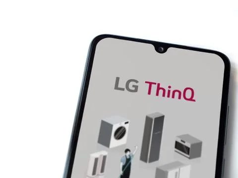 LG ThinQ app launch screen with logo on the display of a black mobile smartph Stock Photos