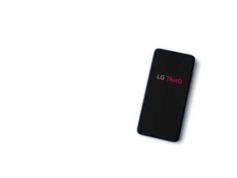 LG ThinQ app launch screen with logo on the display of a black mobile smartph Stock Photos