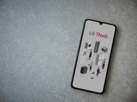 LG ThinQ app launch screen with logo on the display of a black mobile smartph Stock Photos