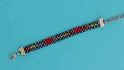 LGBT bead pattern bracelet in blue background. Close up Stock Footage 267814958