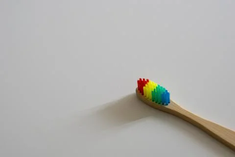 LGBT concept. Close up of Bamboo Rainbow Dental Toothbrush. Stock Photos