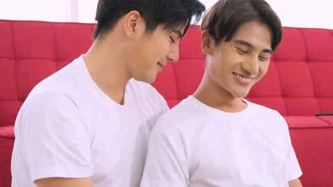 Lgbt couple using laptop computer laughing enjoying each other. Video stock 144965411