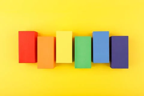 LGBT flag made of rectangular geometric figures on yellow background. Fotos de archivo