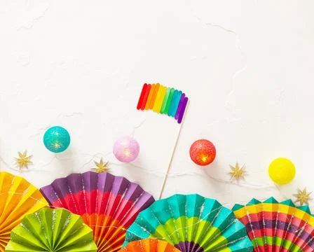 Lgbt holiday card with colorful paper fans, lightening and lgbt flag Stock Photos