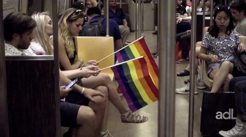 LGBT rainbow flags on subway train interior - Gay Pride in NYC 库存影片 64959073
