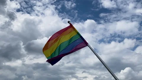 LGBTQ Pride Flag blowing in the wind Видео 253264356