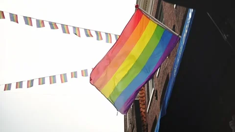 LGBTQ pride flag during pride month of June, blowing in wind in slow motion Stock Footage 196897651
