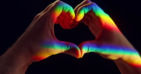 LGBTQ+ Pride Heart Gesture with Two Hands in Rainbow Light on Black Background Stock Footage 341976145