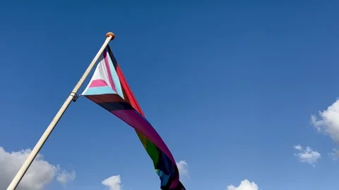 Lgbtq progress flag flying in the sky Stock Footage 260420915