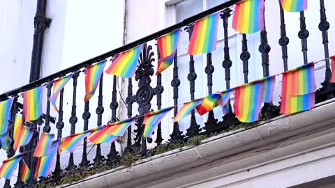 LGBTQ Rainbow Mini Flags Balcony Waving in Wind Stock Footage 241268366
