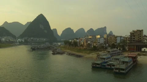 Li river and karst scenery at sunset.  Yangshuo city with boats and karst hills Stock Footage 68893624