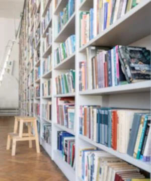 Library with bookcases. Many different books on the shelves. Large selection of Stock Photos