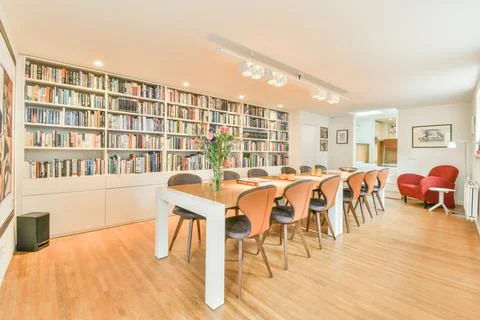 The library in the condo has a long dining table 写真素材