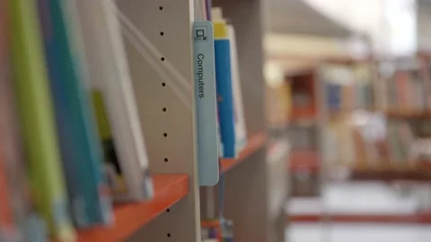 Library filing system indicating section with books on computers Stockbeeldmateriaal 221751378