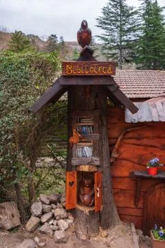 A library inside of a tree trunk with animals carved on wood Stock Photos