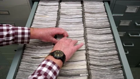 Library Male hands sorting through files in a drawer of Microfiche, closeup shot Stock Footage 237771988