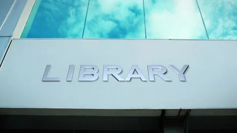 Library Sign on Modern Building with Cloud Reflection on Windows Glass Stock Footage 303560781
