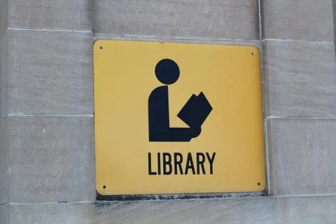 Library sign on a stone wall Stock Photos