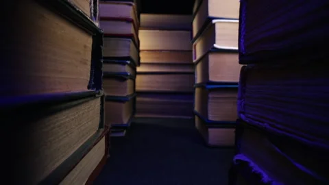 Library stack of old books slider moves on aisle in colorful neon shop,bookstore Stock Footage 248087346