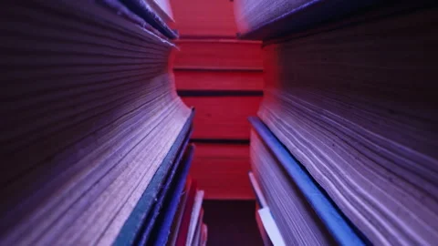 Library stack of old books, slider macro footage in colorful neon shop,bookstore Video stock 248088861