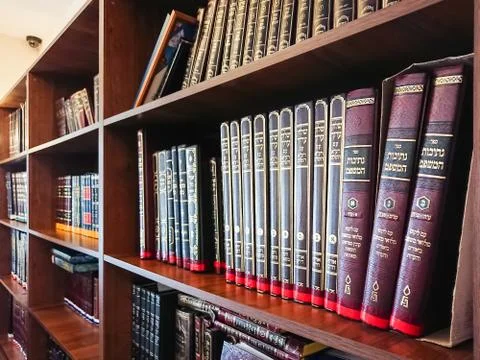 Library in the synagogue. Multi-colored books on the bookshelf in the library Stock Photos