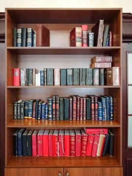 Library in the synagogue. Multi-colored books on the bookshelf in the library Stock Photos