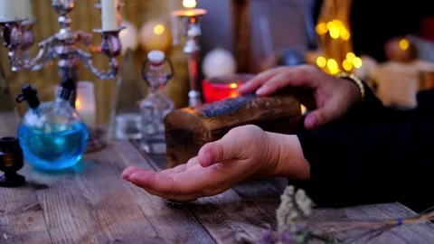 Librate with pendulum over male client's hand, healing or oracle foretellin.. Stock Footage 243274380