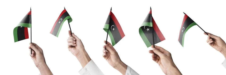 The Libya flag in hand in different angles on a white background Stock Illustration