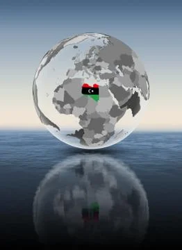 Libya on translucent globe above water Stock Illustration