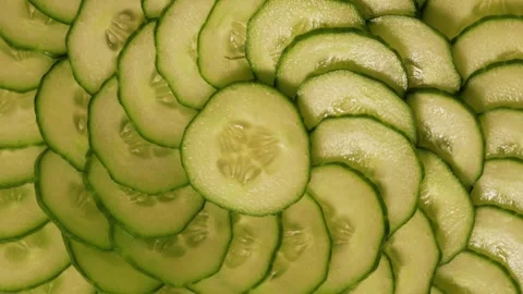 Liced ​​cucumbers are laid out on a glass plate in a circle and rotate. Stock Footage 304701816